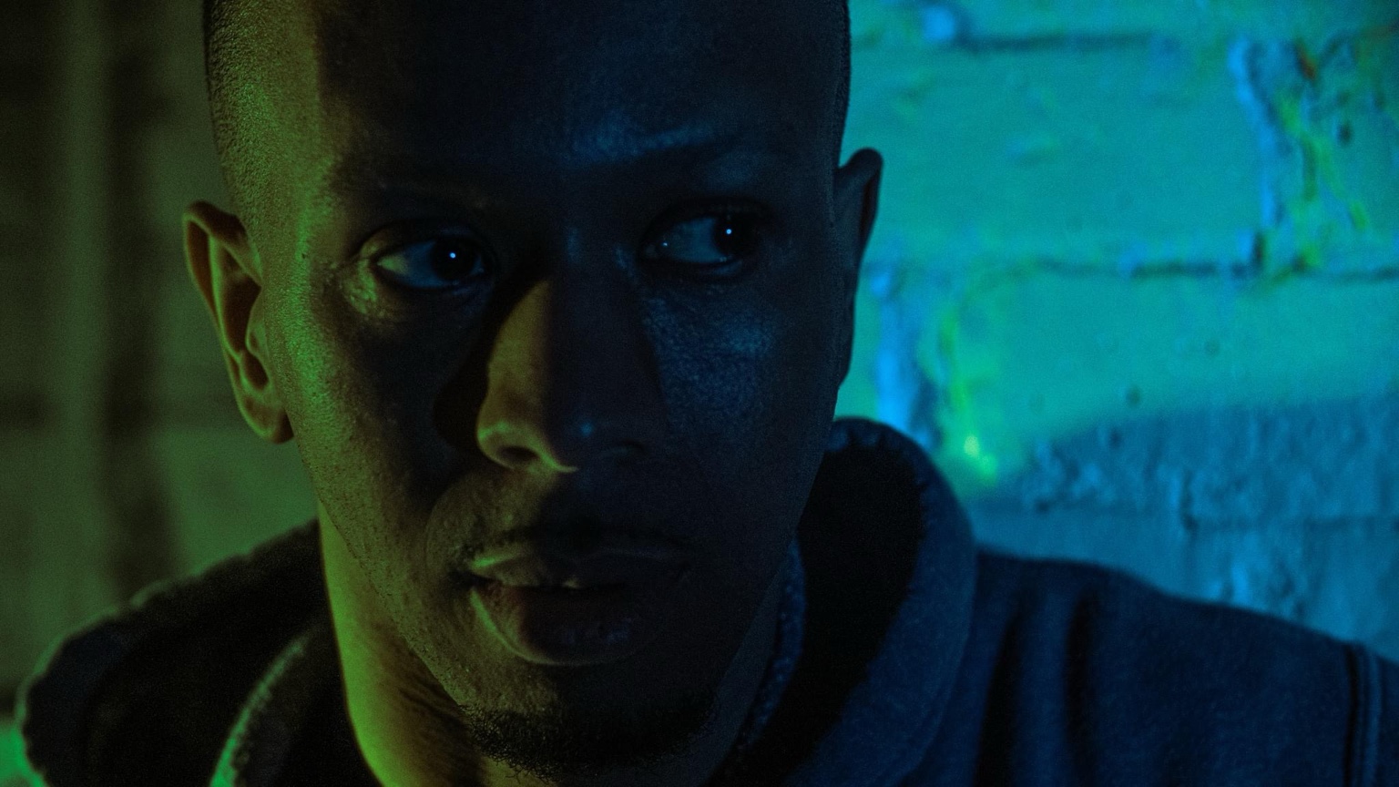 Close-up of Keenan Laurino in green and blue light