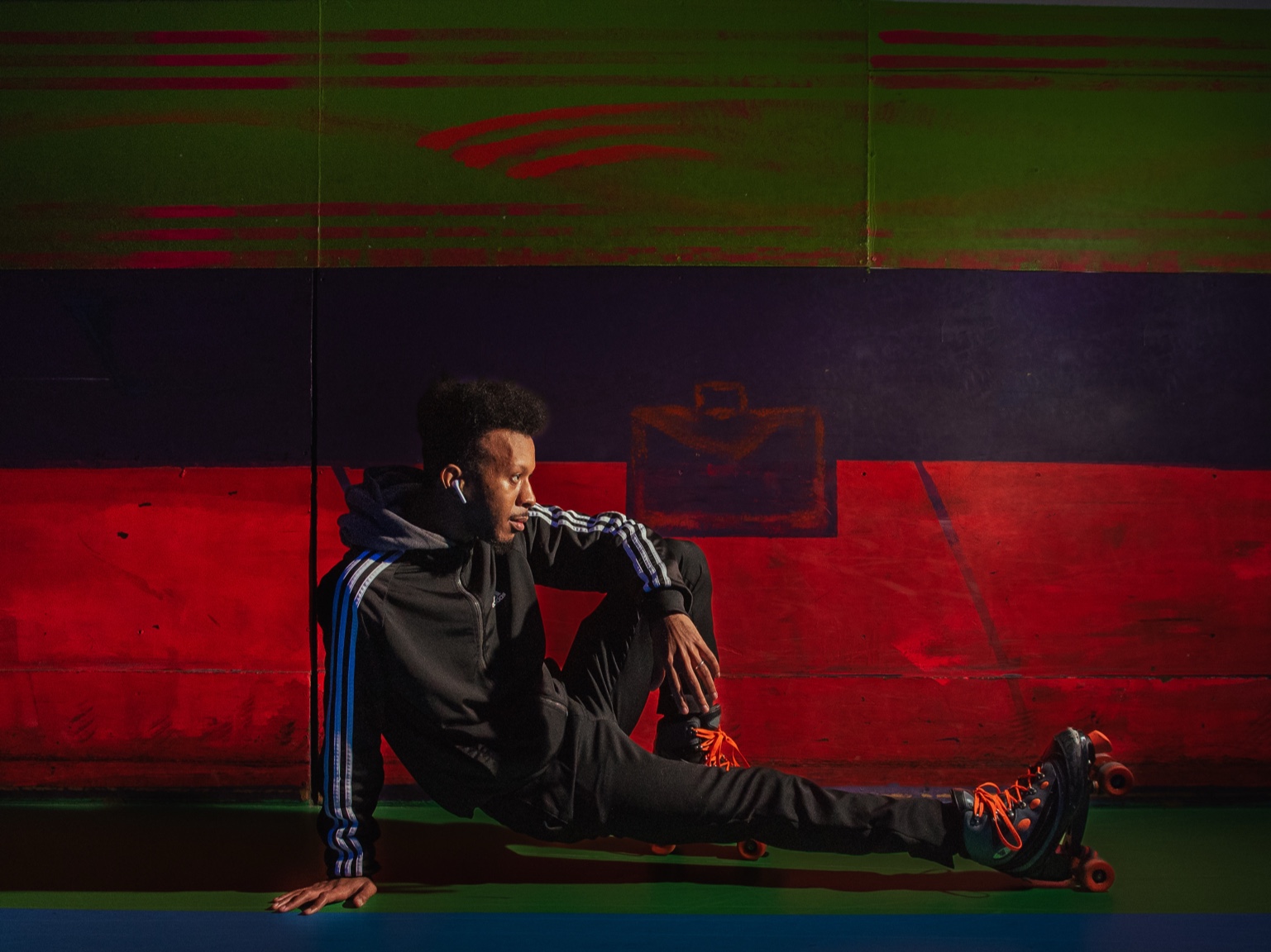 Keenan Laurino on roller skates by colorful wall